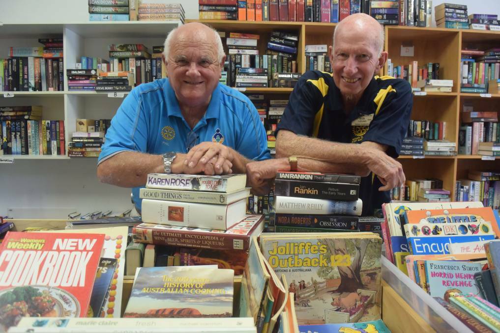 PAGE FOR EVERYONE: Phil Perry and Bob Cleland sort through donated books in the lead-up the Rotary Club of Port Macquarie's Giant Book Sale.