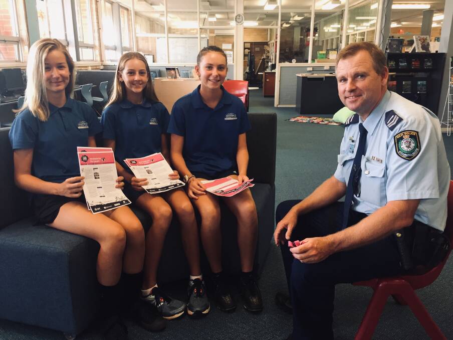 ONLINE EDUCATION: Students Phoebe Flint, Phoebe Morgan and Gemma Lawrence with police officer Steven Jeffery talking about online safety. PHOTO: Laura Telford.