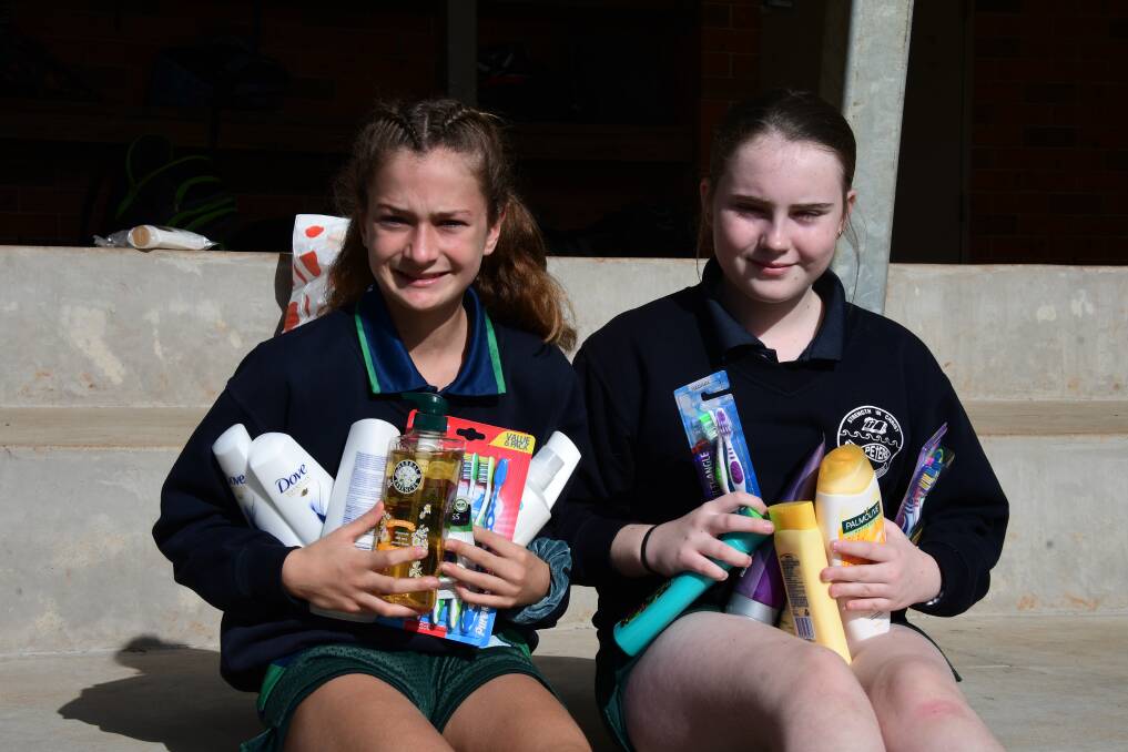 HELPING HAND: Georgie Maher and Kira Lewis with some of the donated goods. PHOTO: Laura Telford.
