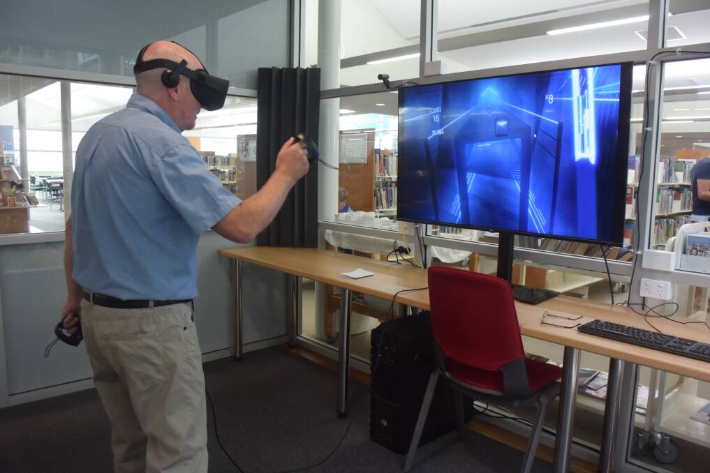 TEST RUN: Port Macquarie Library manager Jim Maguire testing the new virtual reality equipment in the new portal room at the library. PHOTO: Laura Telford.