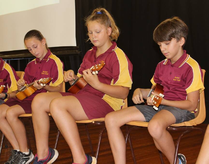 MUSICIANS: Chloe Day, Larnie Vagg and Connor Law performing in front of their school mates.