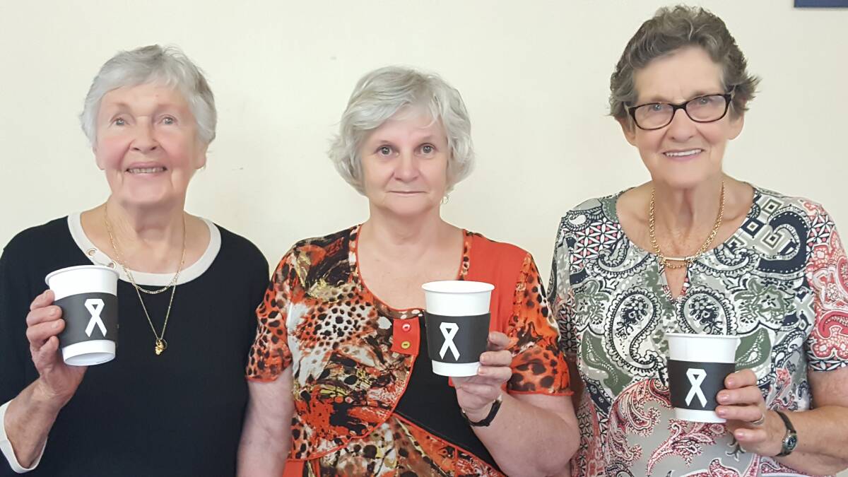 TAKING A STAND: Alva Thomas, Judith Dawson and Hilda Saunders from the Wauchope CWA with the slips being put onto take away coffee cups. Photo: Laura Telford
