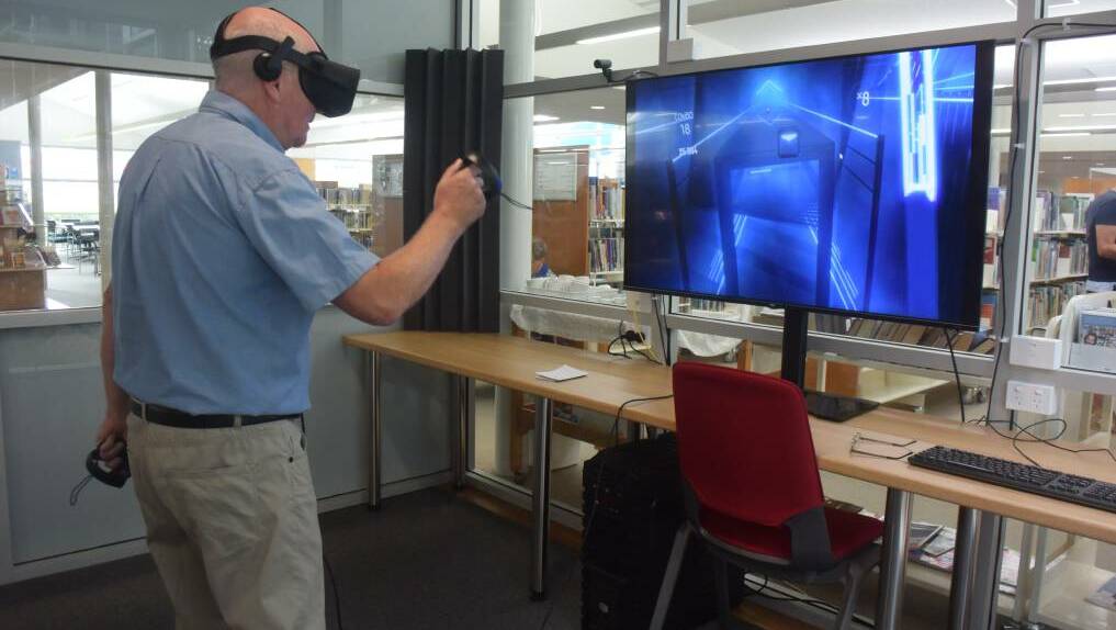 TEST RUN: Port Macquarie Library manager Jim Maguire testing the new virtual reality equipment which will be on display at The Glasshouse. PHOTO: Laura Telford.