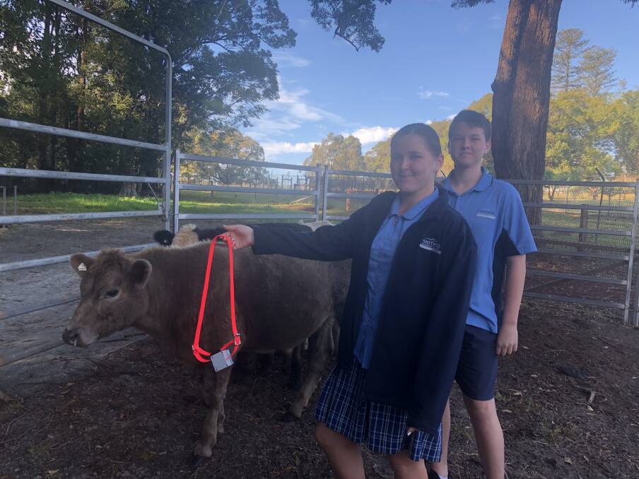 SCIENCE: Esta-Louise Byron and Izzac Hemsley with one of the devices which would attach to a cow or sheep.