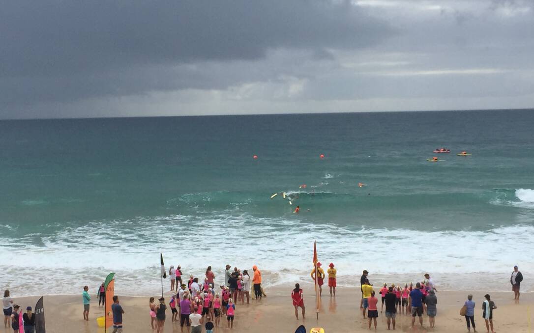 BLACK SKY: Nippers were in the water as the black clouds rolled into Port. Photo: Laura Telford