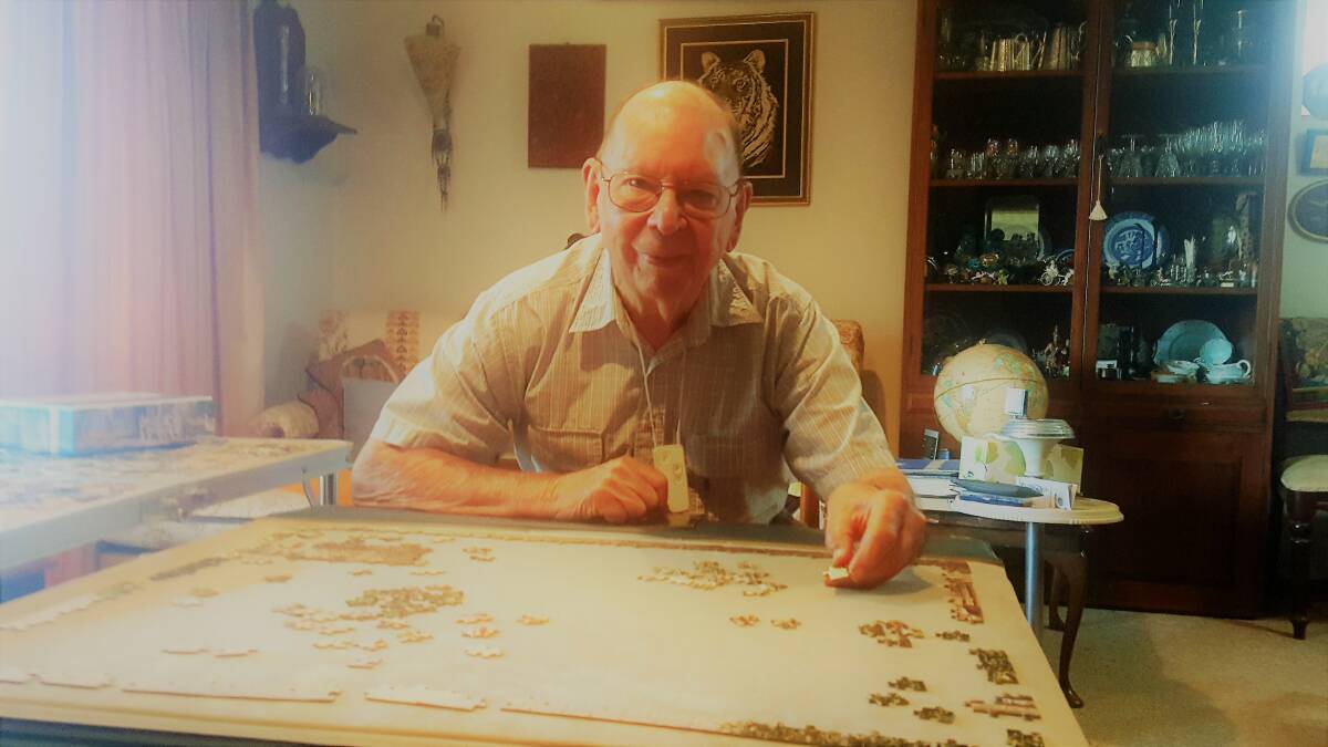 AT HOME: Alan at one of his favourite places in front of his puzzle table.