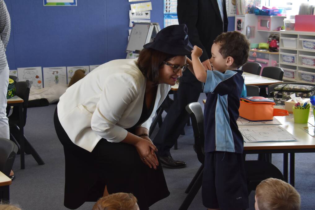 ONE OF US: Education minister Sarah Mitchell recieved her own 'baggy blue' from new kindergarten students.