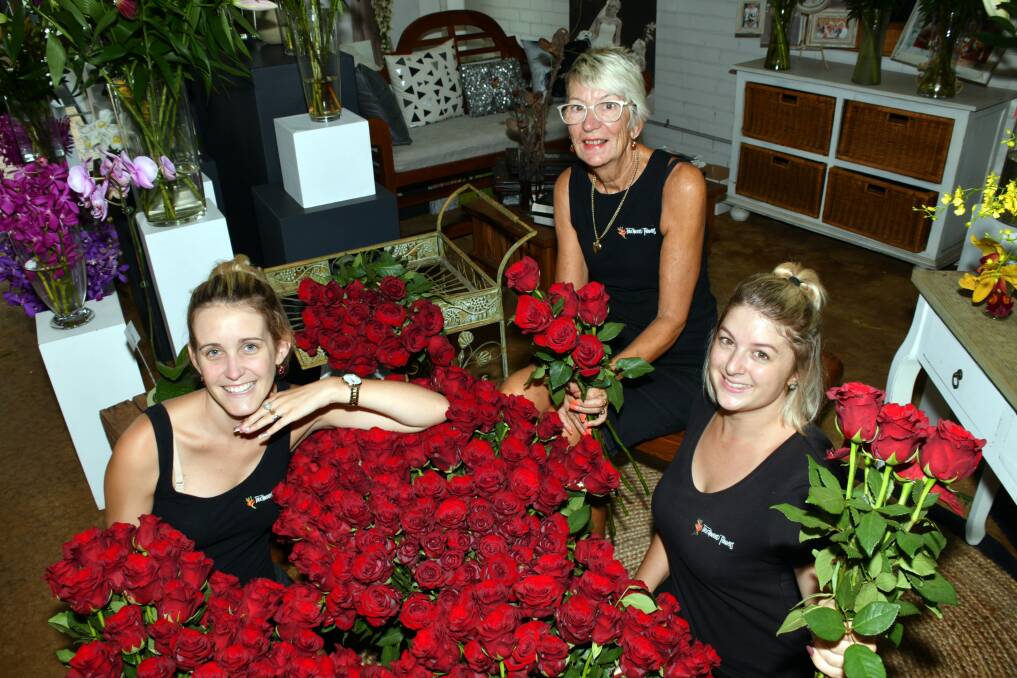 BE A ROSE: Ashley Sargeson, Marilyn Oultram, Kayla Fuller from Touchwood florist in Port Macquarie with just some of the roses for Valentine's Day. Photo: Ivan Sajko.