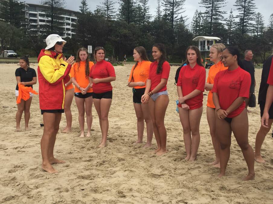 UNDER INSTRUCTION: MacKillop College students getting briefed by a surf lifesaver at the beach. PHOTO: Laura Telford.