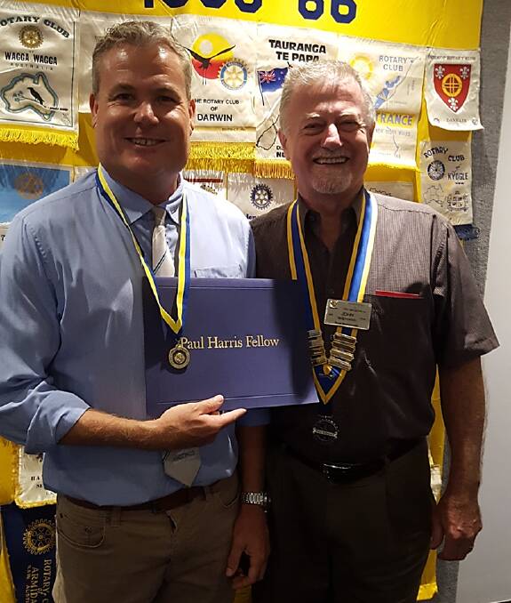 CELEBRATE: Mark White and his Paul Harris Fellow certificate and medal with John Sheppard president of the Rotary Club of Port Macquarie.