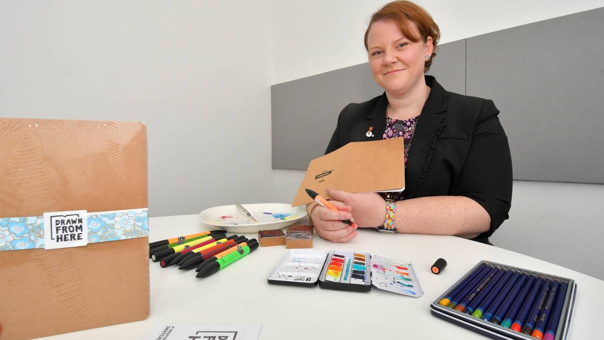 GET CREATIVE: Katherine Appleby with the sketchbooks people will use to create their art. Photo: Ivan Sajko.