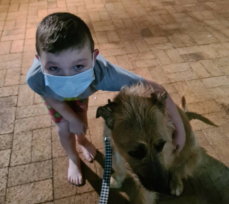 Strong bond: Alessandro giving his dog Lil a hug while in isolation. Picture: Ellen Crepaz. 
