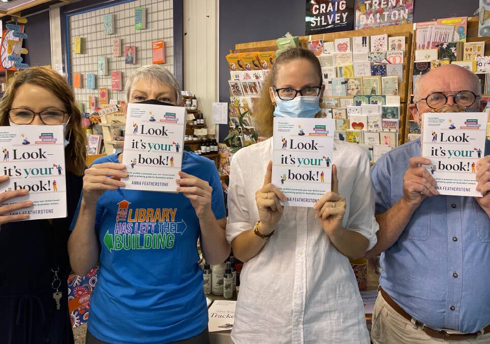 Book Face store manager Cathy Bayes Hunt, Port Macquarie-Hastings events librarian Leanne Wright, Port Macquarie author Anna Featherstone and library manager Jim Maguire hold copies of Look-It's Your Book!