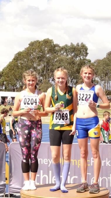 On the podium: Madelaine (middle) with other athletes recognised for their results. Photo: supplied. 