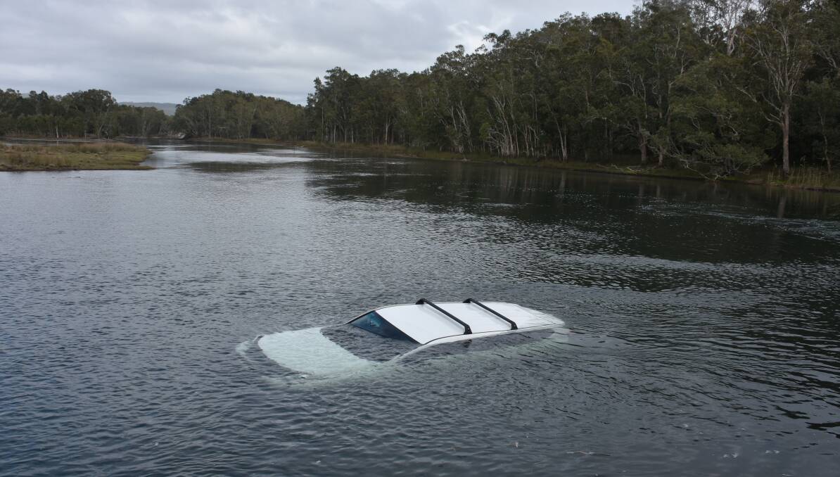 Driver safe: A vehicle landed in the water at Lake Cathie after a driver had a run in with a huntsman at about 10am on Tuesday, November 1.