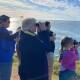 People watch the whales from Tacking Point Lighthouse on June 26. 