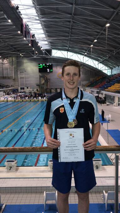 Clean sweep: Nash Wilkes wears his medals and holds the certificate which acknowledges his record. Photo: supplied. 