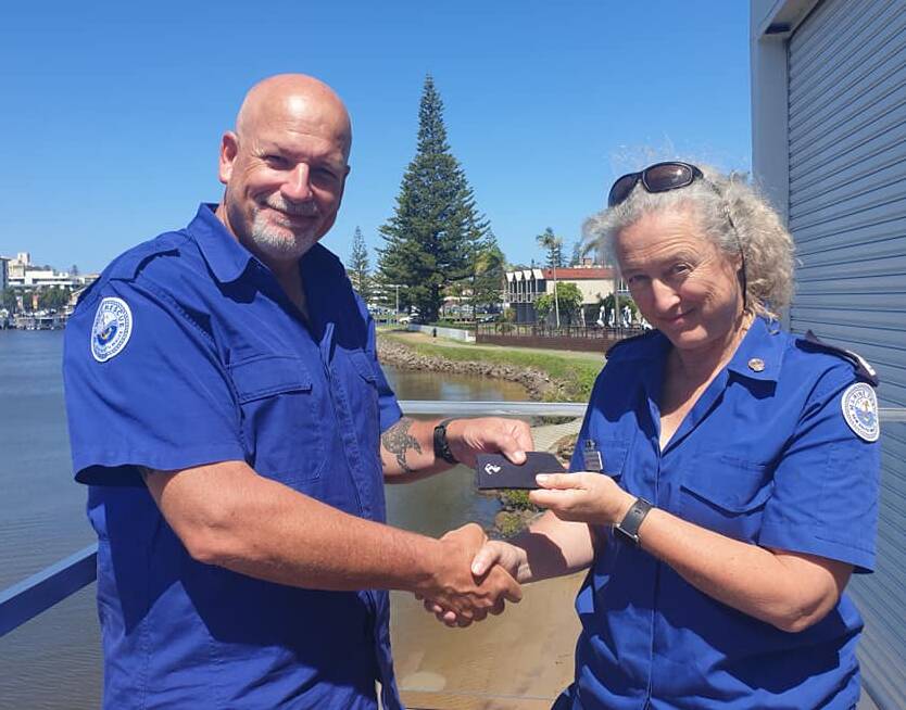 Proud to serve: New recruit Ian Brougham receives his badge from Marine Rescue Port Macquarie training officer Ali Cameron-Brown. Picture: Marine Rescue Port Macquarie. 