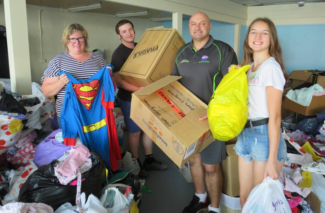 Hardworking: Peta Watters, Clayton Purkis, Jason Purkis and Hayley Purkis help sort the items for the garage sale. 