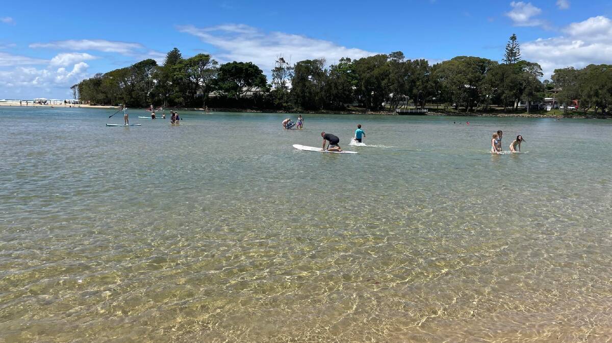 Lake Cathie's lagoon was full of people on boards and kayaks. 