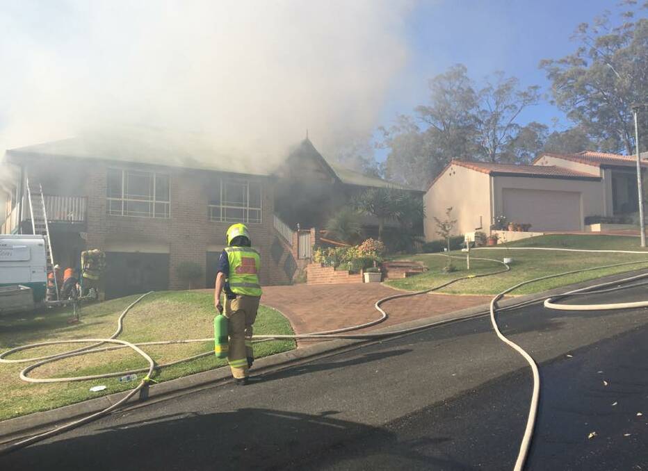 Port Macquarie firies are currently battling a house fire in Quarry Rise. Photo: Tracey Fairhurst. 