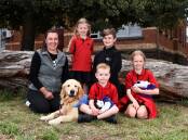 THERAPY: Jacqui MacMillan with dog Honey and Buninyong Primary pupils (back) Ruby, Rylan and (front) Euan with Muffin the guinea pig and Isla with Bluey. Picture: Adam Trafford
