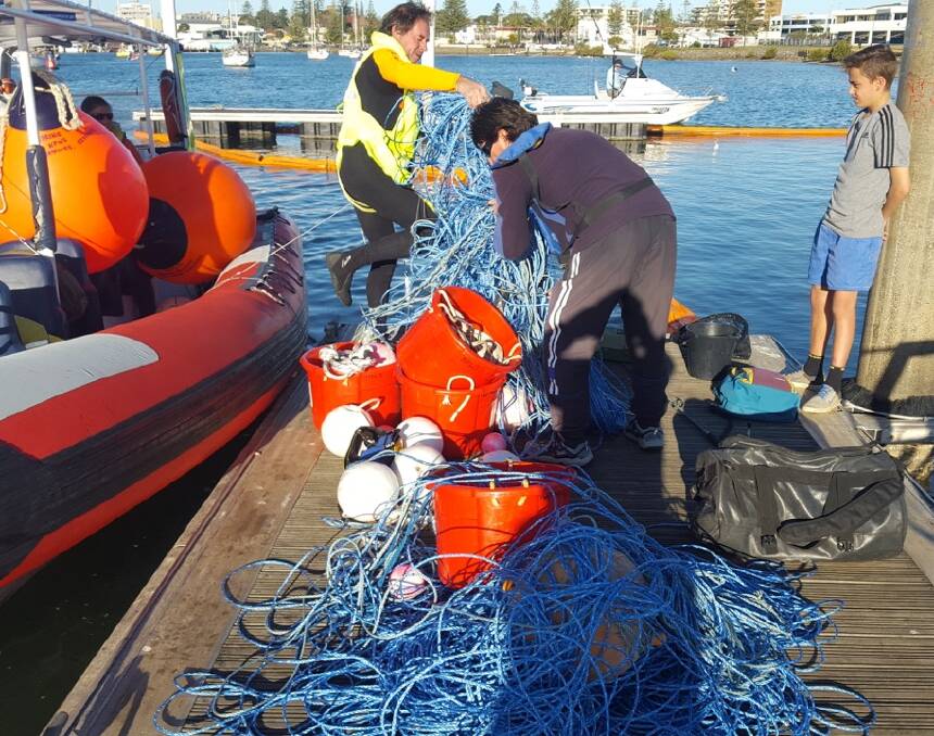 A mess: The Wildlife Rescue team with the entanglement retrieved from the whale off Port Macquarie. Photo: Jodie Lowe