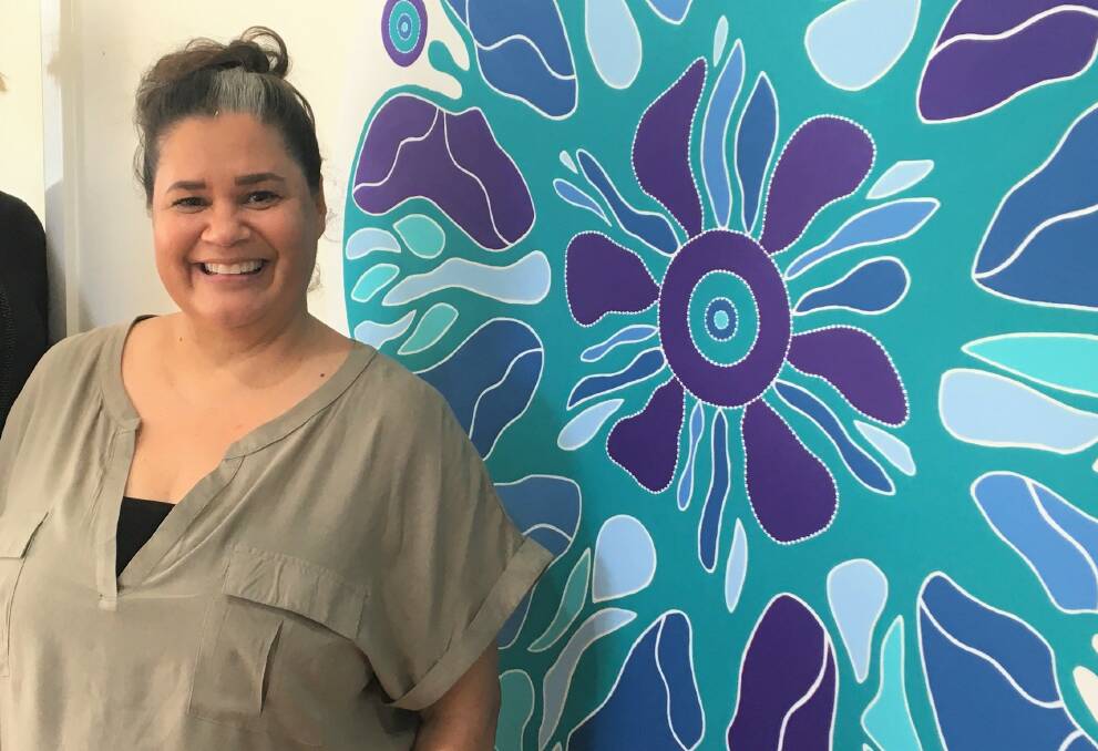 Angela Marr-Grogan with her piece Galbaan Wakulda - Women Together as One - unveiled during NAIDOC Week at Liberty Domestic and Family Violence Specialist Service.