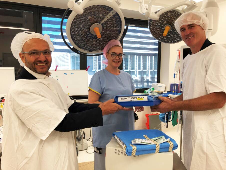 Jim Bruce Urology and Prostate Cancer Trust representative Peter Besseling (right) presents the resectoscope to Urologist Dr Nader Awad and Perioperative Nurse Manager Belinda Garvey.