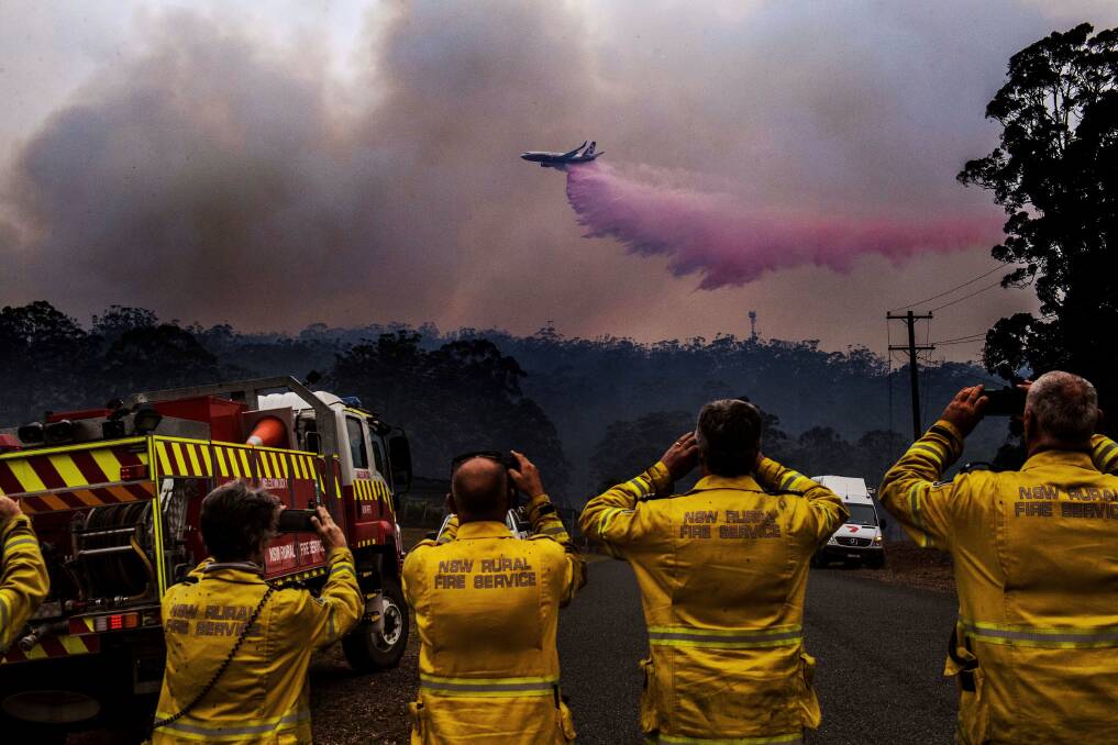 RFS volunteers in awe of the might of the LAT as it drops fire retardant on the Hastings fires in 2019. Photo: Nick Moir, SMH.