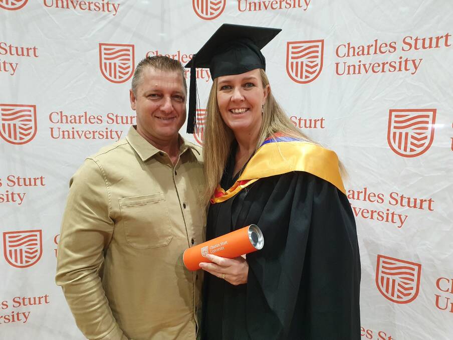 Achiever: Vanessa Kos with her husband Michael at her graduation ceremony.