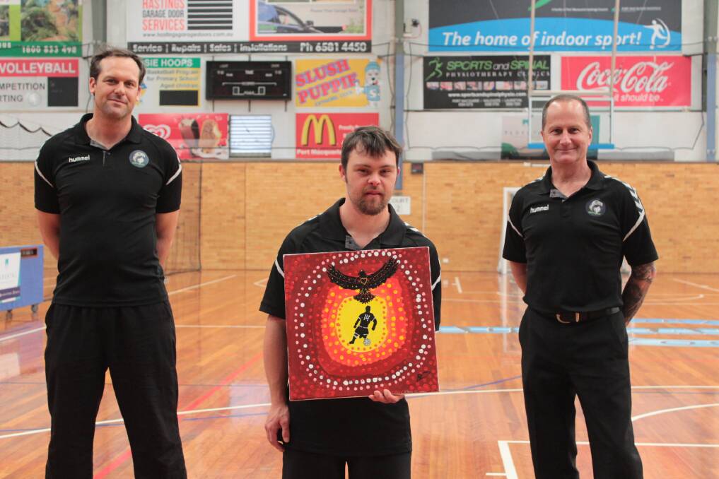Family first: Chris Whitfield, Braydon Stevens with his artwork and Mick Day of East Coast Eagles' All Abilities FUTSAL.