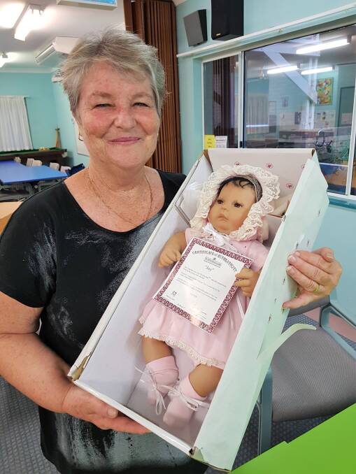 Voluntuneer Stephanie Wright with one of many treasured items, a collectables doll from Ashton-Drake Galleries, being offered for sale on 20 November.