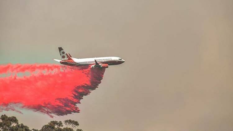 Fire suppressant retardants are dropped from aircraft during firefighting operations. Photo credit: Brittany Daly.