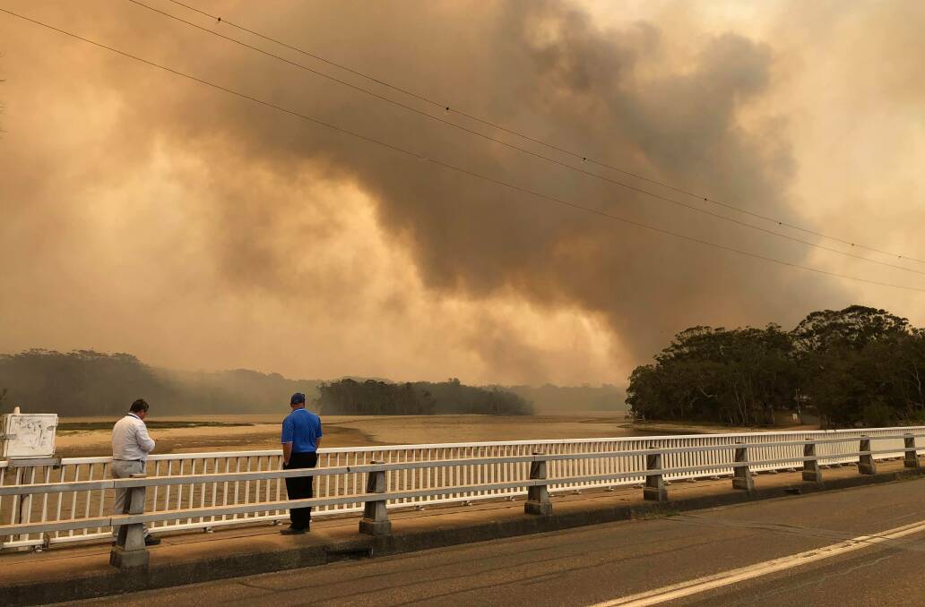 Dramatic: Lake Cathie ablaze as captured from the bridge. Photo: Lisa Willows.
