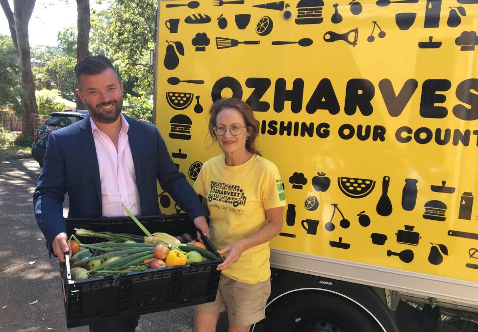 Kind donation: CEO for Lewis Land Group Matthew McCarron with OzHarvest volunteer Helen Roebuck.