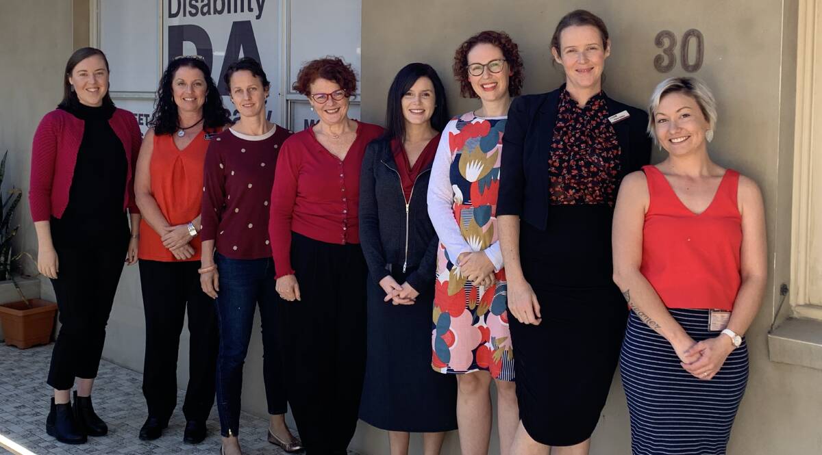 Port Macquarie Hastings Domestic Violence Committee members Holly Lawson, Leanne Rodburn, Haley McEwen, Ruth Edwards, Jami-Lee Clark, Brooke Maggs, Fiona Healey and Tianna Bailey wearing red in preparation for the Seeing Red campaign.