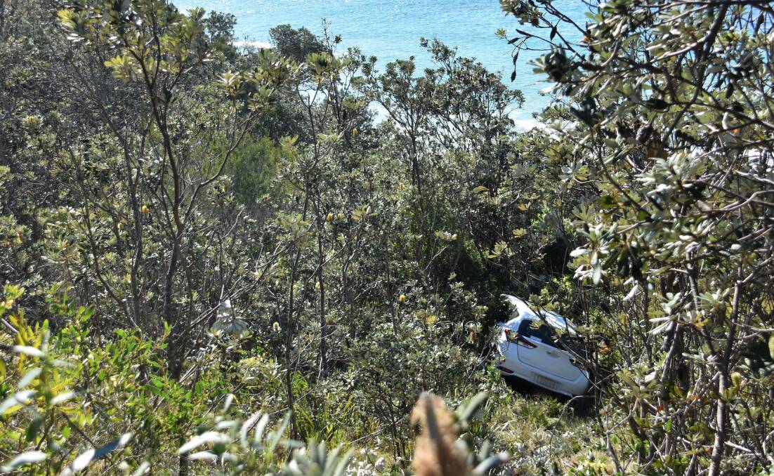 The car came to rest in bushland a few metres short of the Coastal Walk footpath below.