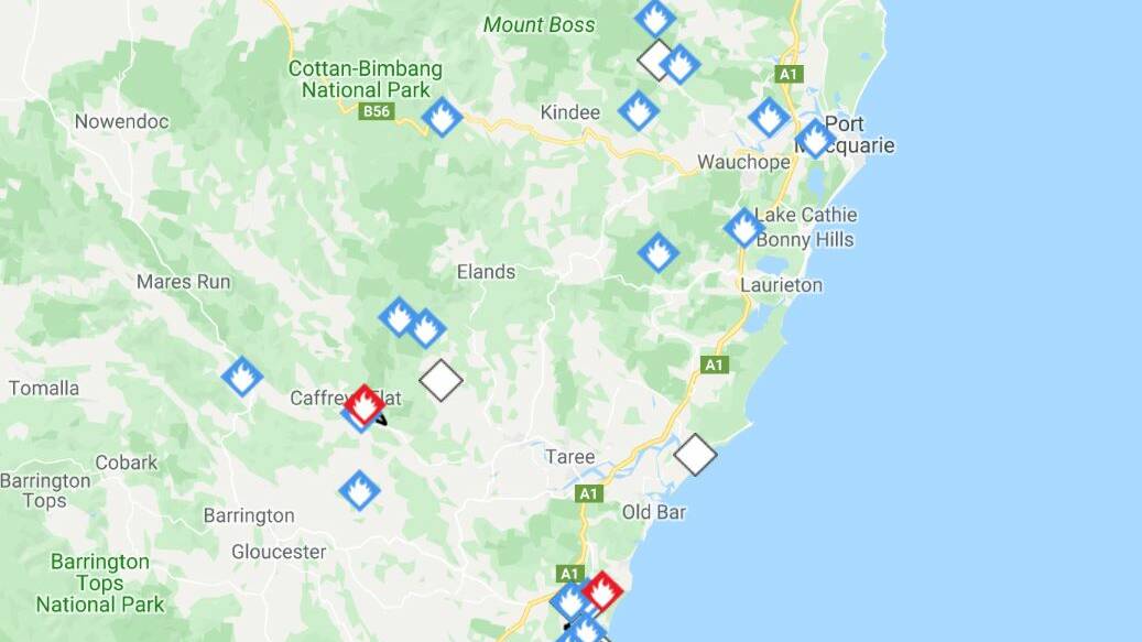 Mid North Coast fire crews are battling two emergency level fires as blazes erupt across the region in testing conditions.