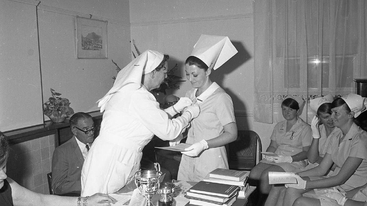 Graduation: Nurse Helen Hagan receiving a graduation prize from Matron Usher, 1971.