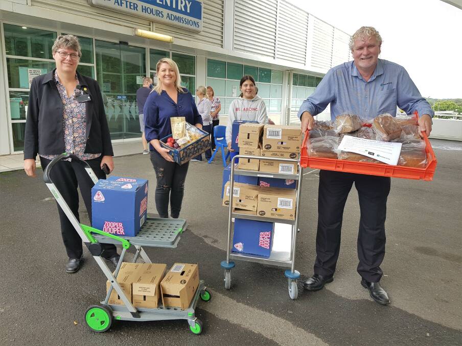 Thank you: Port Macquarie Base Hospital General Manager Catharine Death expresses her gratitude for the snacks delivered to hospital staff. With her is Rebecca Stockwell of Frontline Needs Our Help, Rebeccas daughter Montana Rowsthorne and Tim Walker of Hastings Co-op.