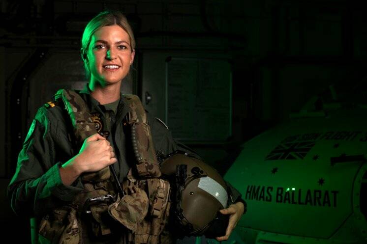 Maritime Aviation Warfare Officer, Sub Lieutenant Ashley Hill, stands in front of the MRH-60 helicopter, callsign Convict, embarked on HMAS Ballarat for Exercise MALABAR 2020. Photo: The Navy Daily, LSIS Shane Cameron.