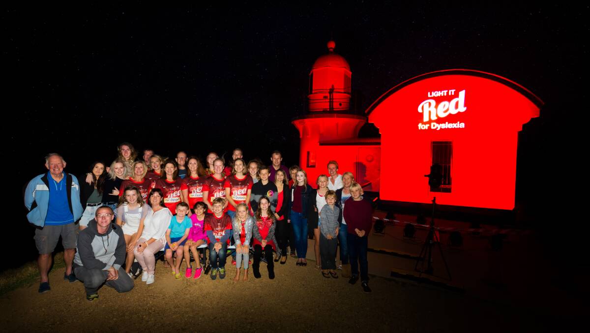 Shining the light: Tacking Point Lighthouse lights up red for dyslexia awareness. Photo: Ivan Sajko.