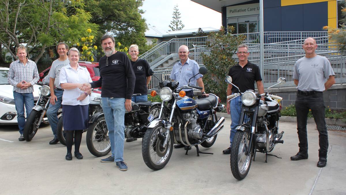 Palliative Care Nursing Unit Manager Mary Trotter thanks Port Macquarie Classic Motorcycle Club president Ian Stone for the donation. With them are club members Bill Perfrement, Dave Edwards, John Butler, Roger Vance, Lance Munro, Tim Brown, and their magnificent, classic machines.
