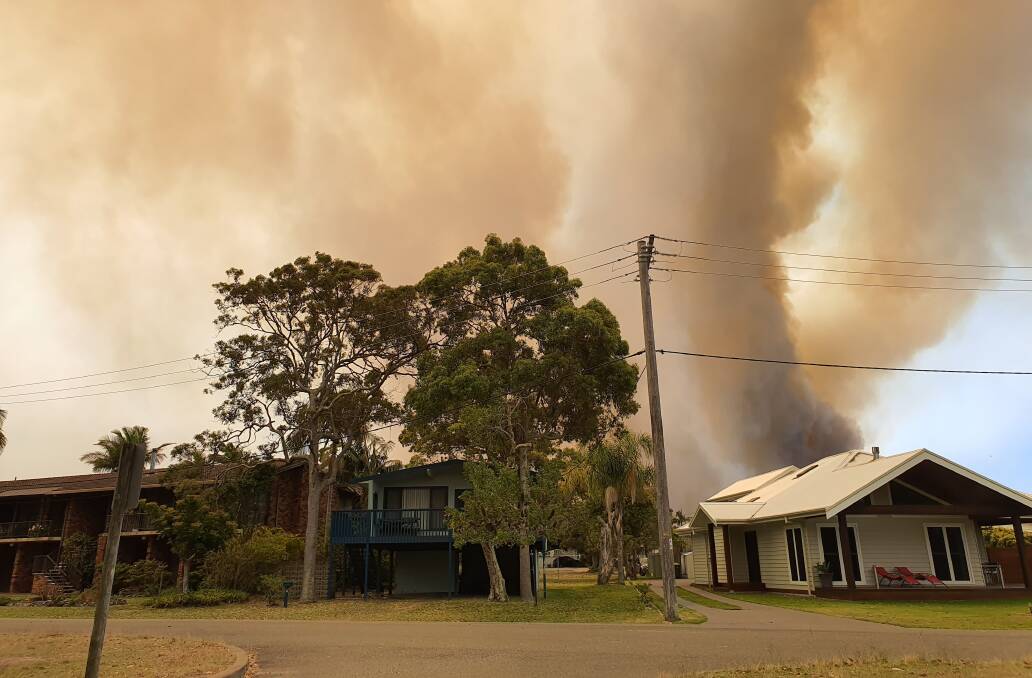 The fire has reached the Lake Cathie area and residents are being urged to be prepared to leave. Photo: Laura Telford.