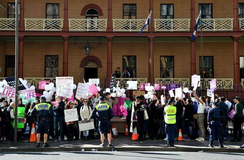 Pro-life and pro-choice protesters outside state parliament.