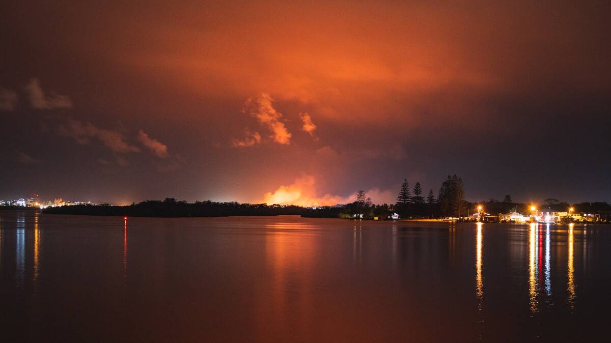 Fire glow: A shot of the Crestwood fire burning overnight as seen from the North Shore of Port Macquarie. Photo: Patrick Linehan.