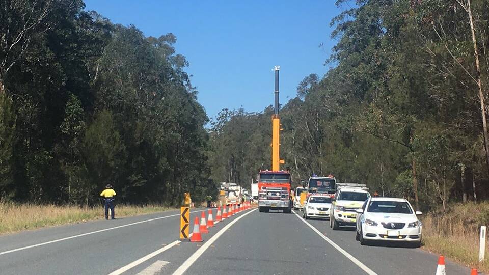 A crane has been called in for a salvage operation after four trucks were involved in a crash on the Pacific Highway near Telegraph Point. Photo: LiveTraffic.