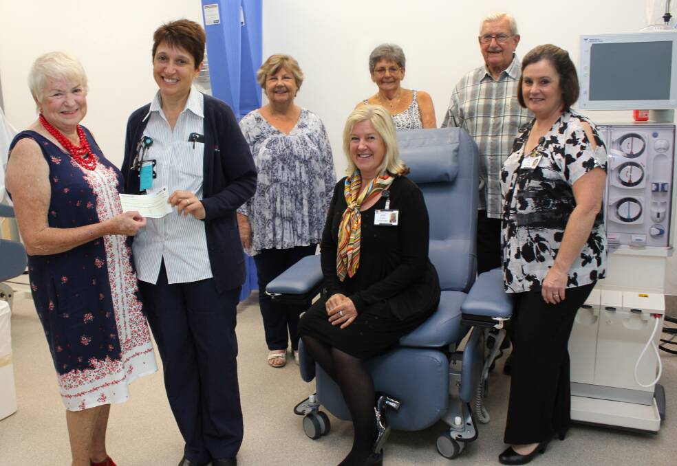 Craft show organiser Dian Barnes hands the proceeds of the Dahlsford Grove Lifestyle Village craft show to Hastings Macleay Renal Services Nursing Unit Manager Trish Campbell. With them are Bev Thomson, Pauline Grant and Reg Schneider of the Lifestyle Village and (seated) PMBH General Manager Jane Evans and Director of Nursing Penelope Pink.