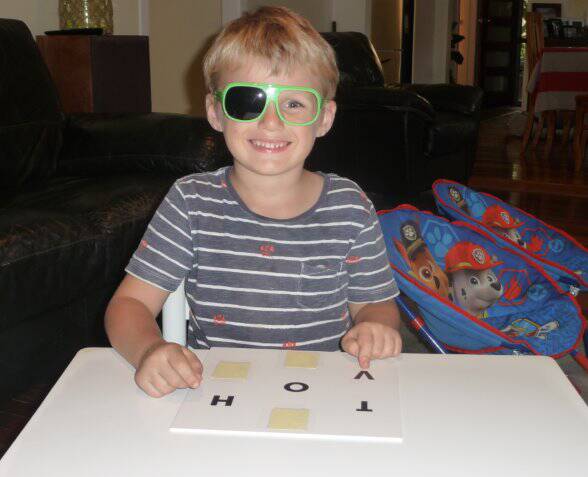 Darcy points to a letter of the alphabet using the special StEPS glasses.